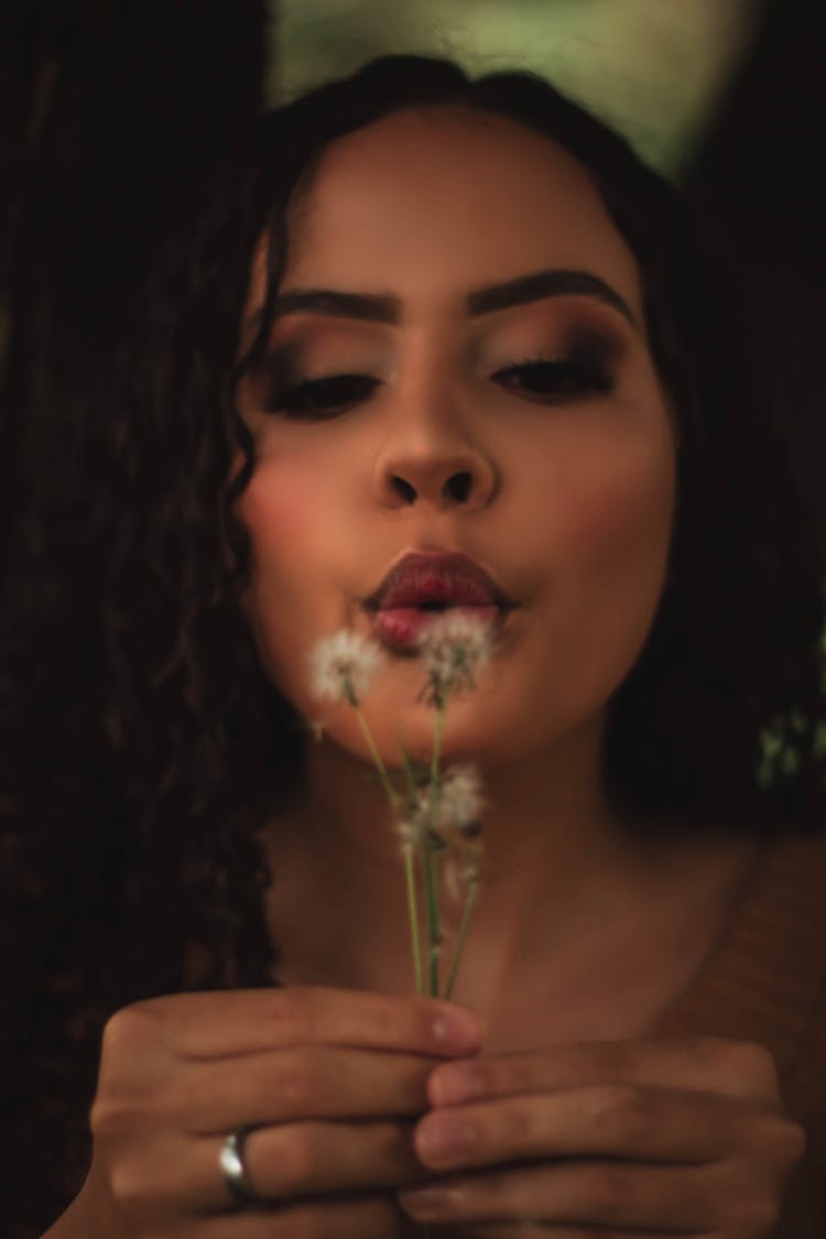 Woman Blowing Dandelion Flowers