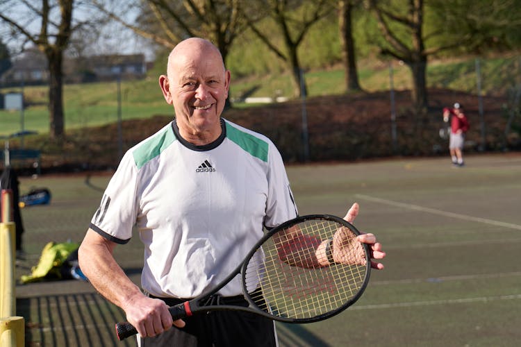 Elderly Man Holding A Tennis Racket