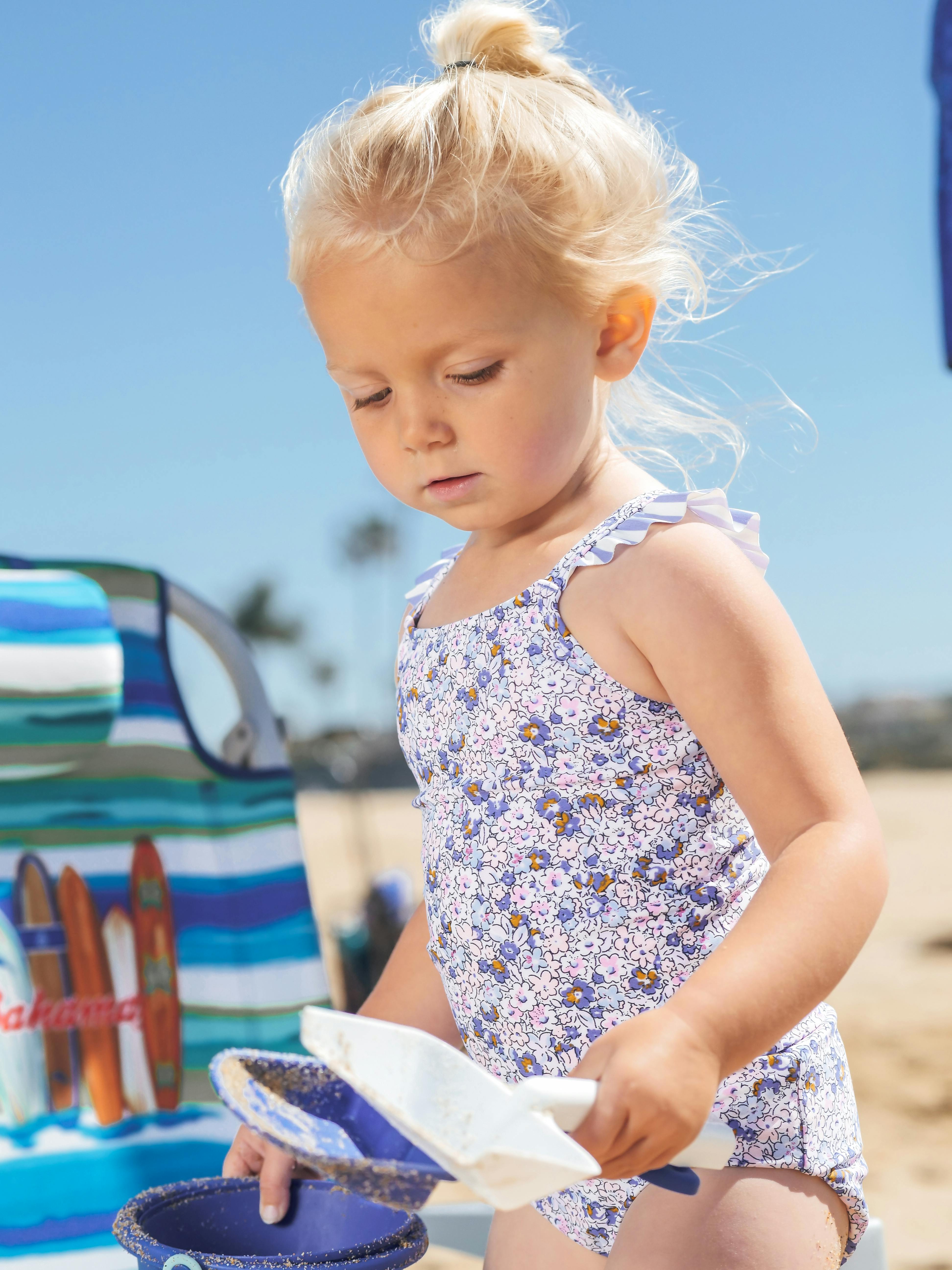 little girl playing on the sand