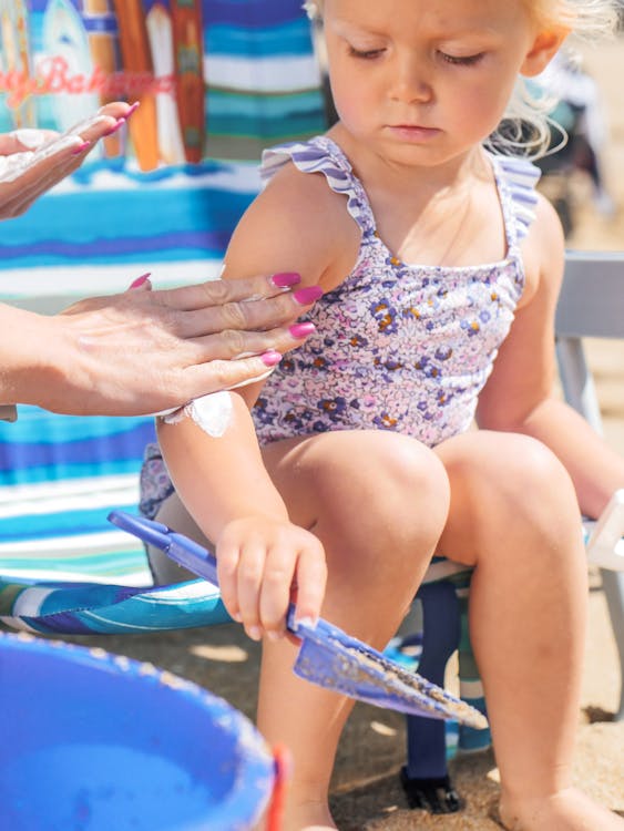 Free Toddler Sitting on Beach Chair Stock Photo