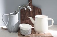 Two ceramic pitchers on a board — photo by İbrahim Doğan on Pexels
