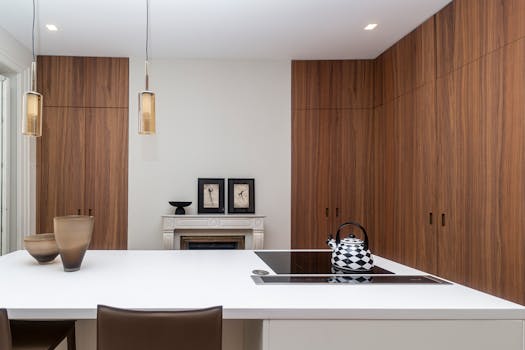Sleek modern kitchen interior featuring a minimalist induction stove on a white island.
