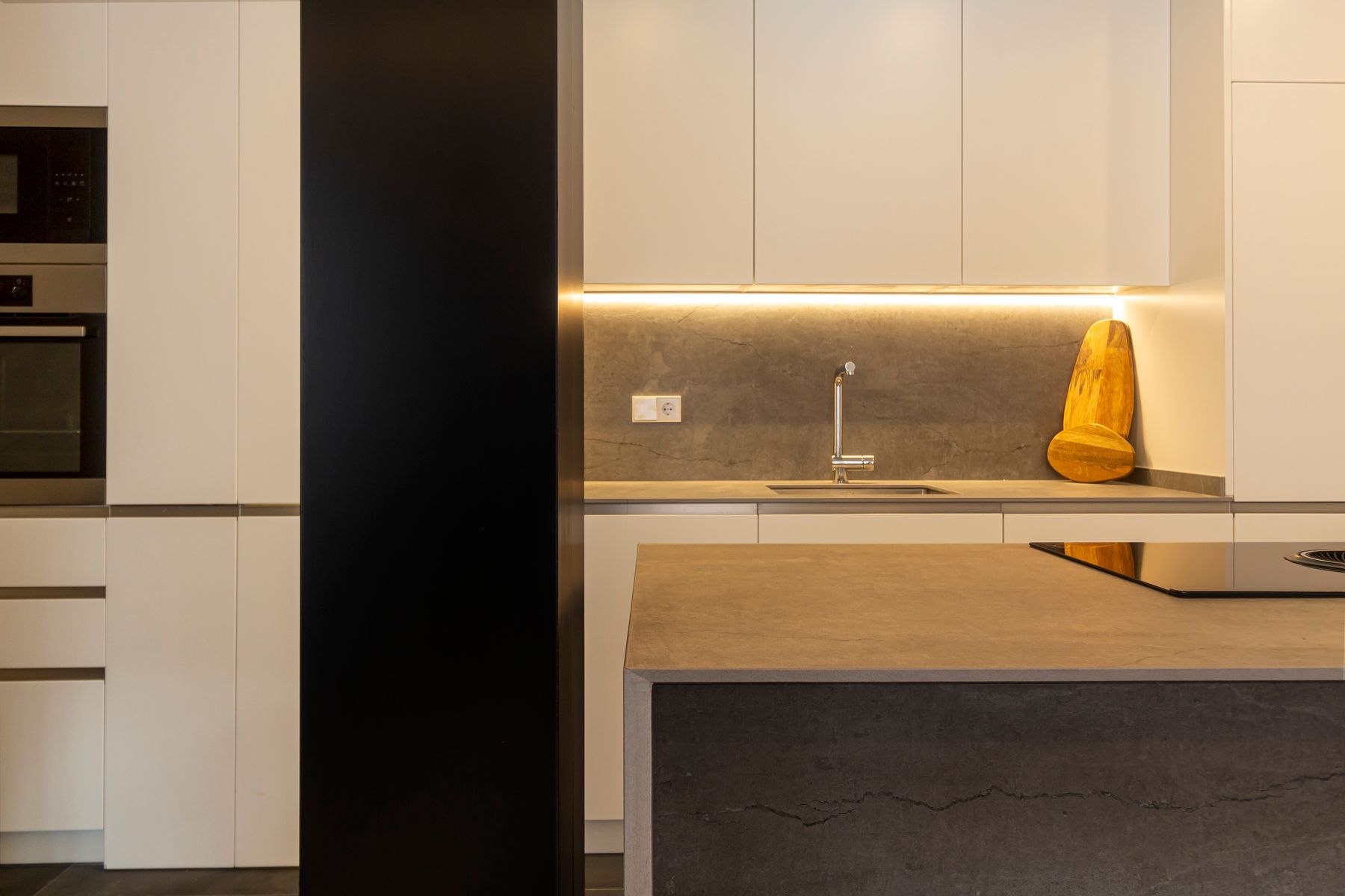Contemporary kitchen with cabinet lighting and a warm illumination scheme over working counters