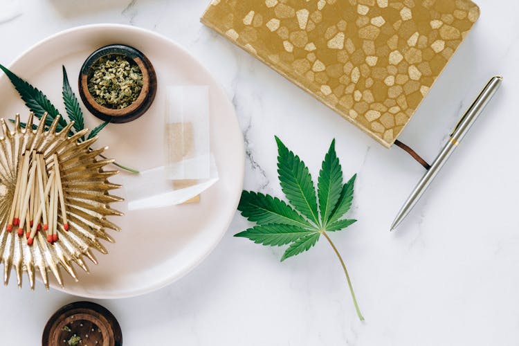 Cannabis Leaf On White Marble Surface 