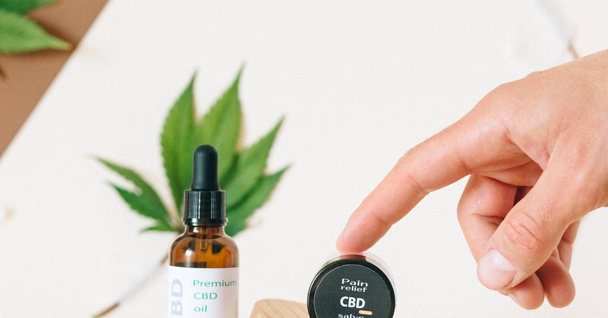 Person Holding Brown Wooden Chopping Board With Black and White Bottle