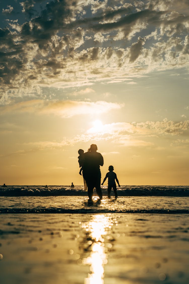 Silhouette Of A Family At The Beach