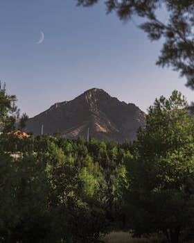 Serene landscape capturing a mountain and crescent moon in Erbil, Iraq.