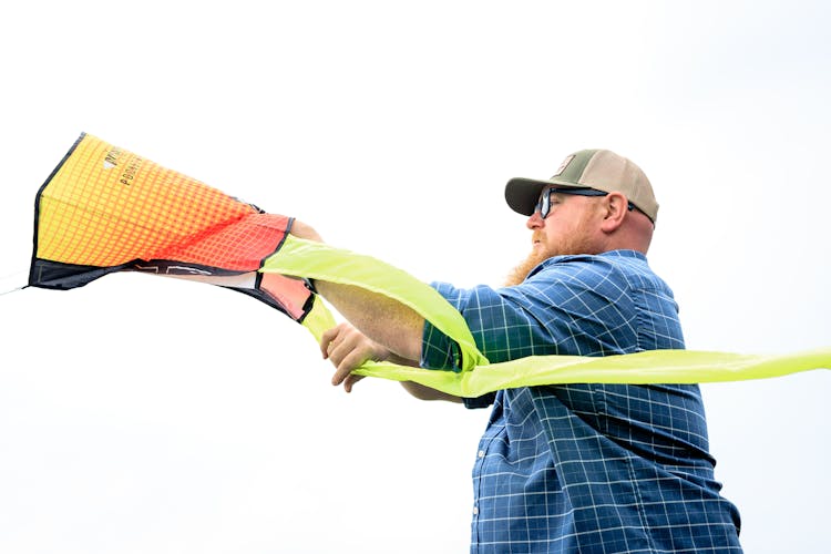 Man Holding A Pocket Flyer Kite 