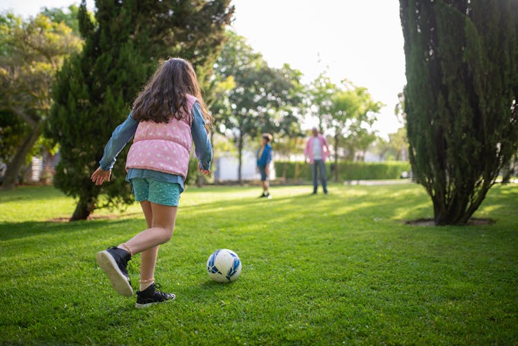 Back View Of A Girl Playing Football 