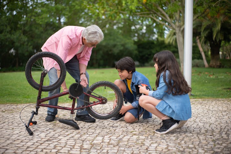 
A Grandfather Teaching His Grandchildren About Bicycles