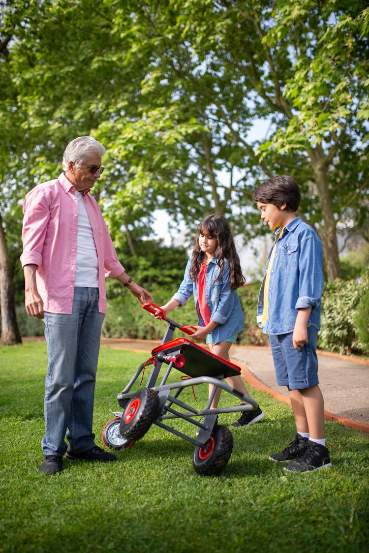 
A Grandfather Spending Time With His Grandchildren At A Park