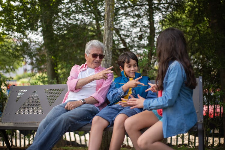 
A Grandfather Spending Time With His Grandchildren At A Park