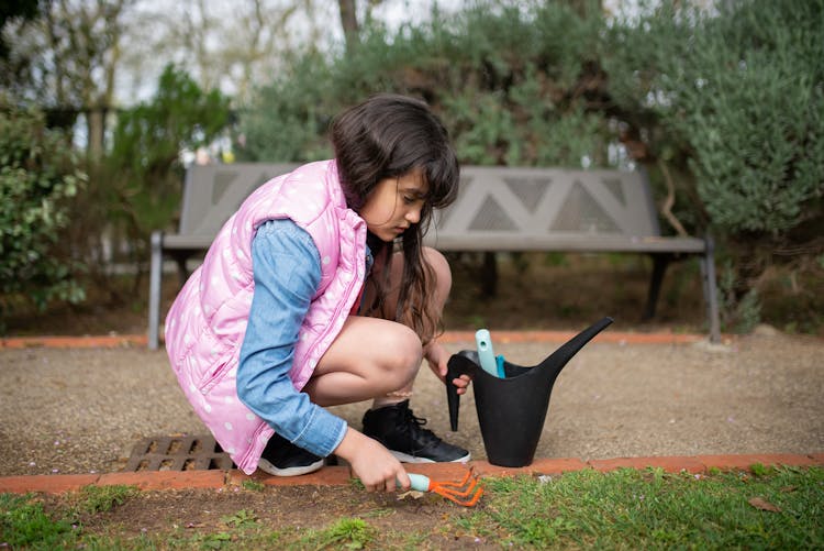 
A Girl Using Gardening Tools