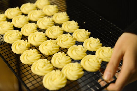 Freshly baked homemade butter cookies cooling on a rack, perfect for dessert lovers.