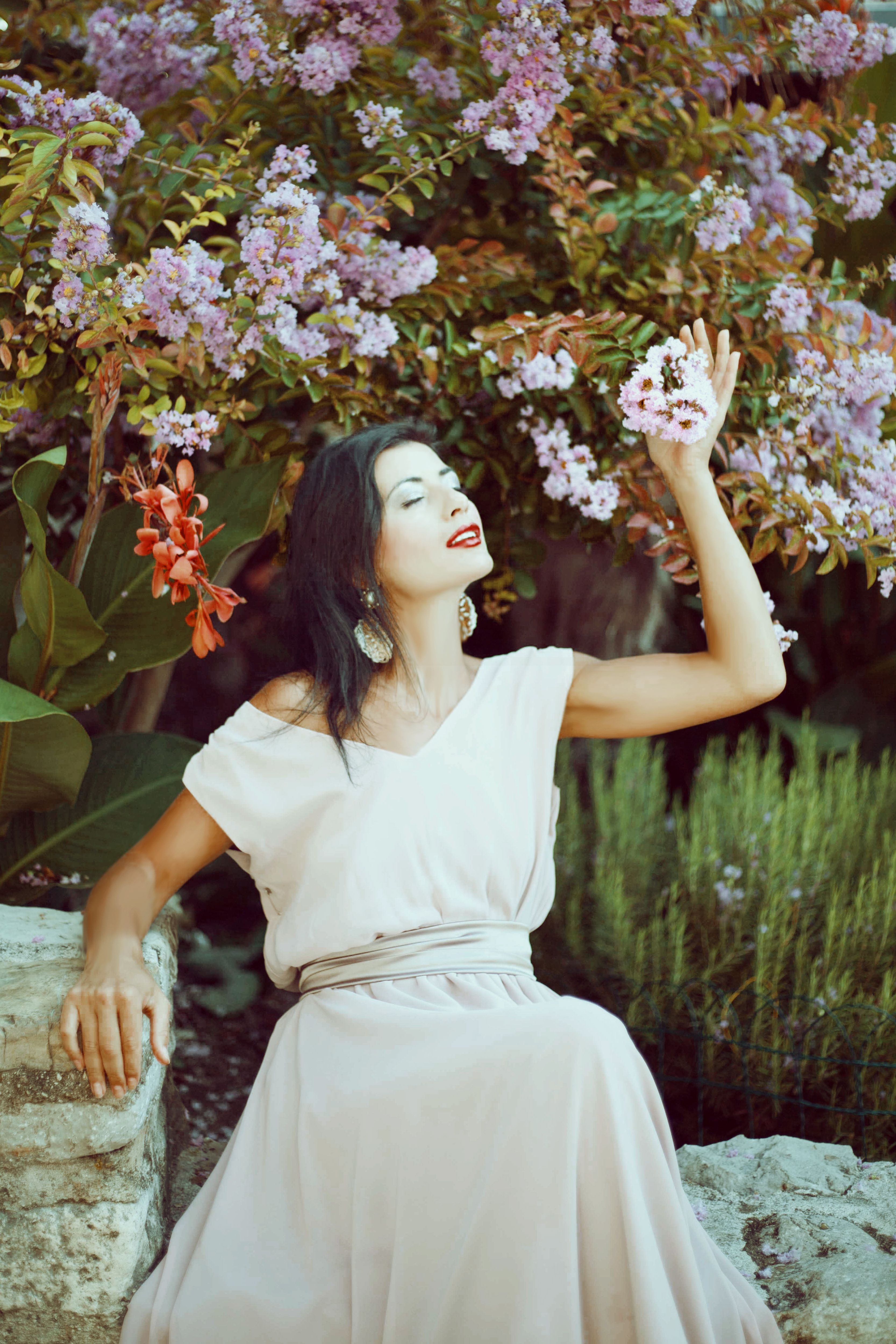 Woman in Dress Posing with Flowers in Garden · Free Stock Photo