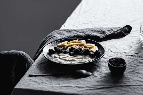 Yogurt and Blackberries on Black Ceramic Plate 