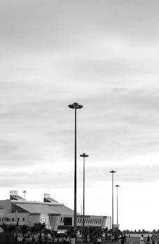 Street view of urban architecture in monochrome with tall structures and people.