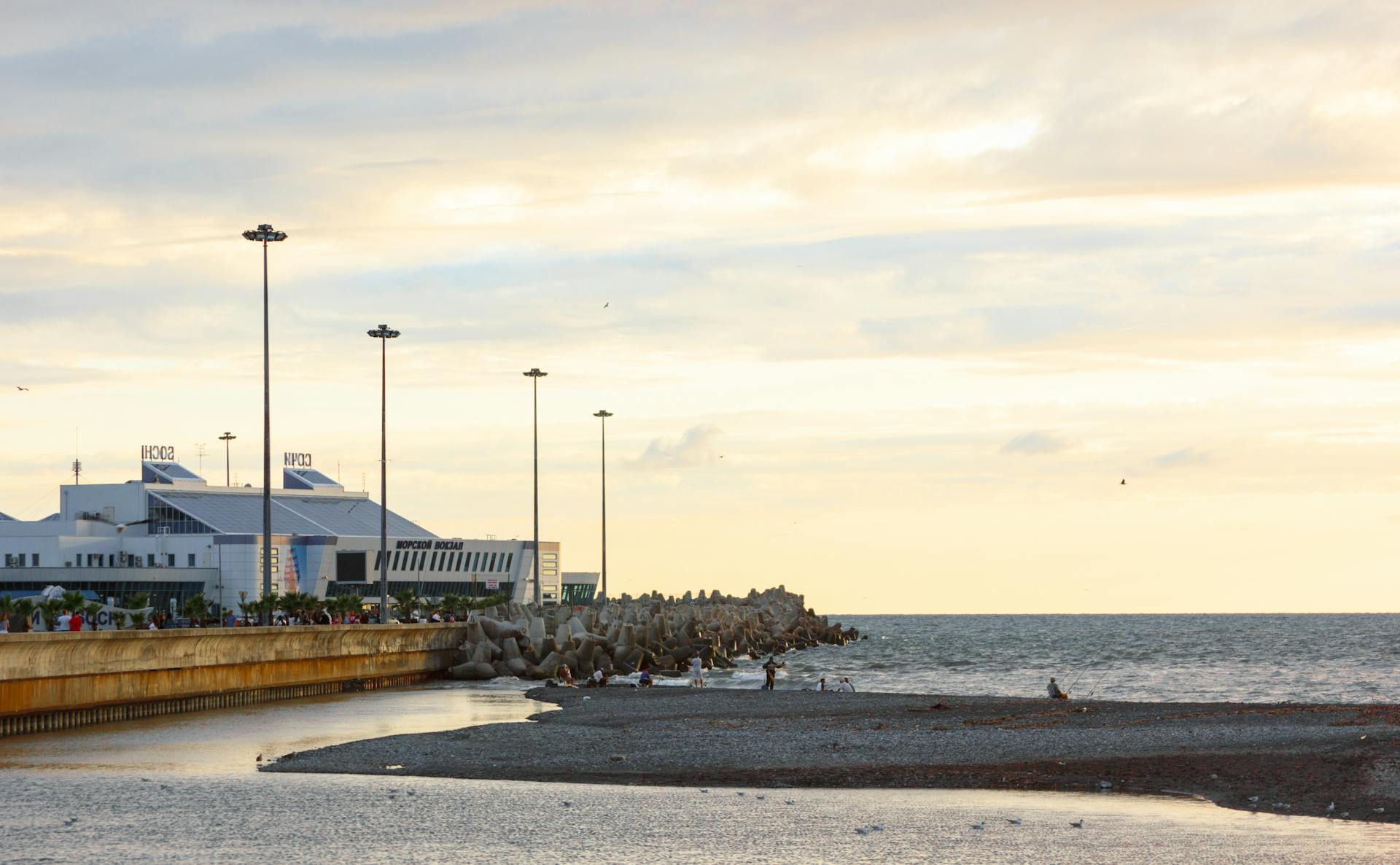 Coastal cityscape with tranquil sea and scenic sunset, perfect for travel inspirations.