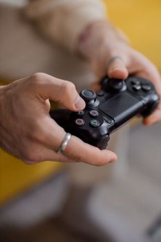Detailed view of hands gripping a gaming controller, emphasizing interactive technology.