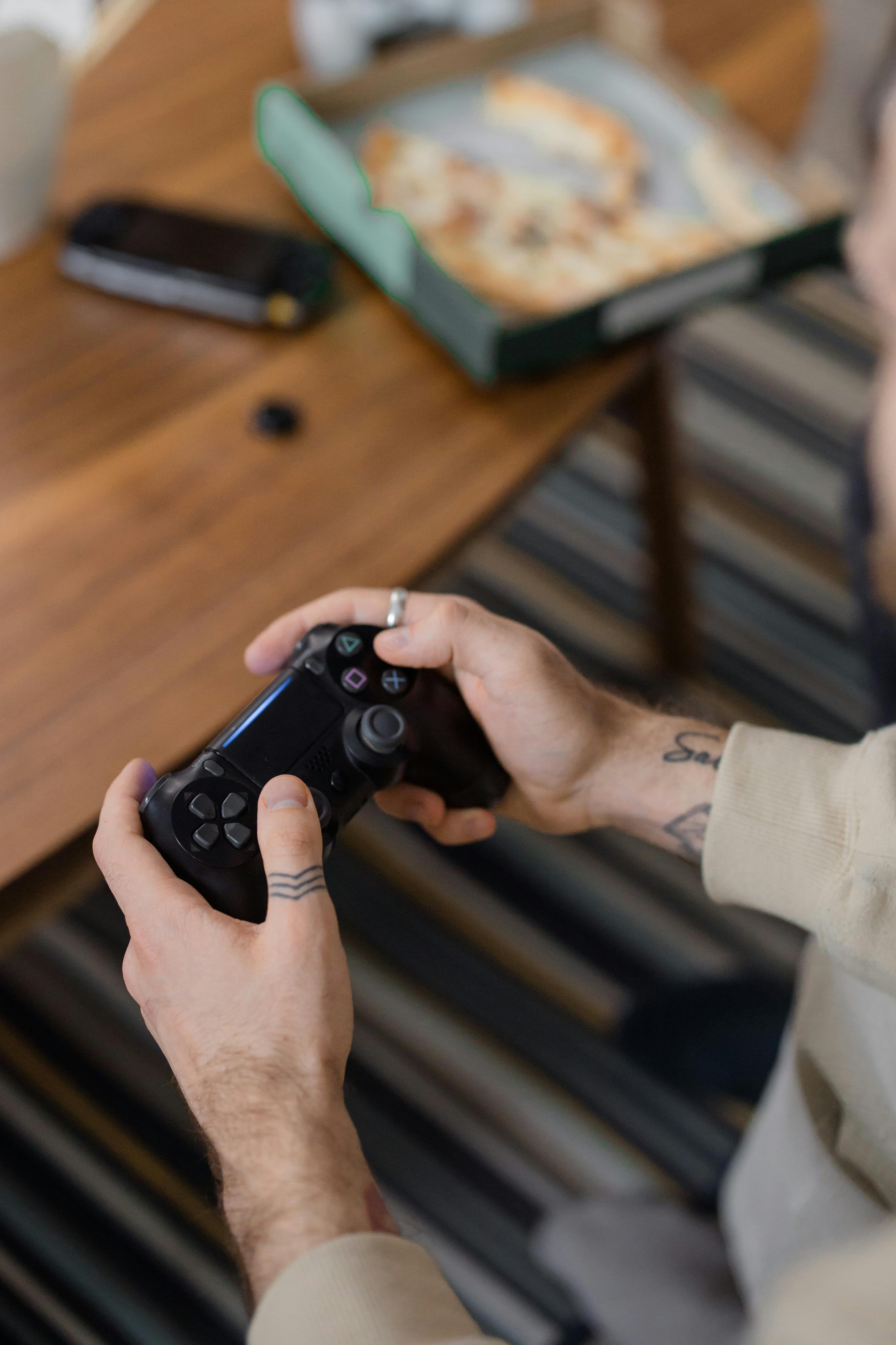 person holding a black game controller