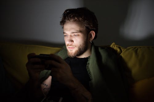 Bearded Man Playing a Video Game Console