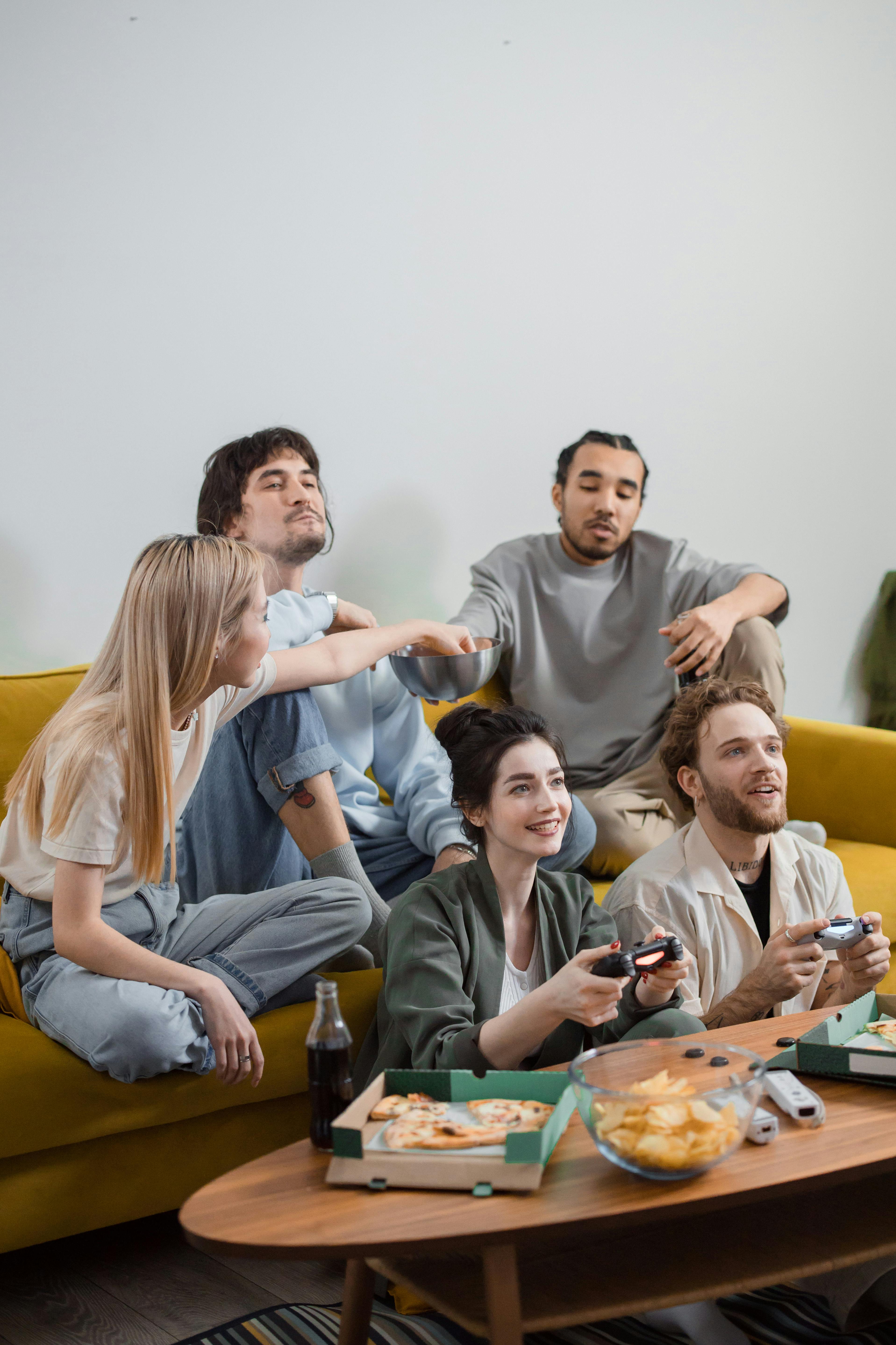 Happy Friends hanging out Together and eating Pizza · Free Stock Photo