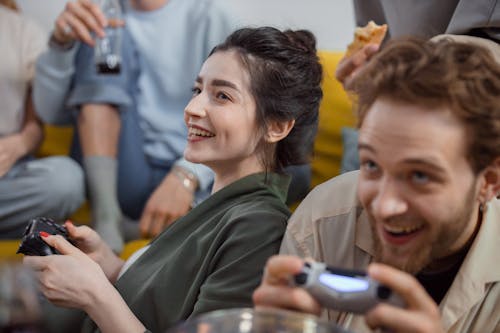 A Happy Woman Playing on a Game Console