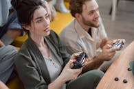 A Happy Woman Playing on a Game Console with a Friend