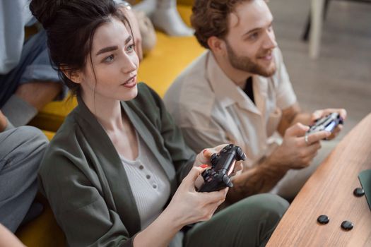 Young adults immersed in playing video games, showcasing fun and friendship.