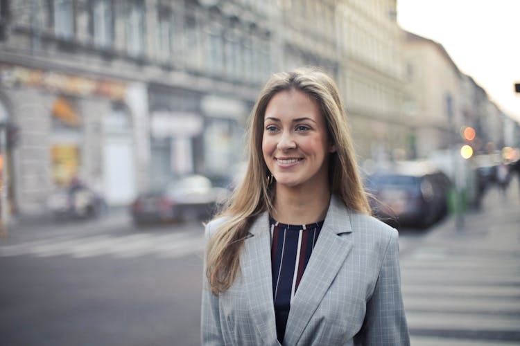 Close-up Photography Of A Woman Wearing Formal Coat