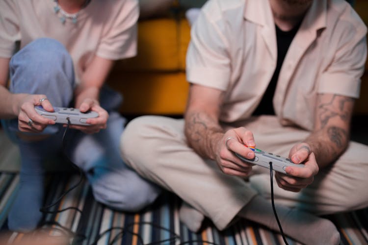 A Man And A Woman Playing Game Console