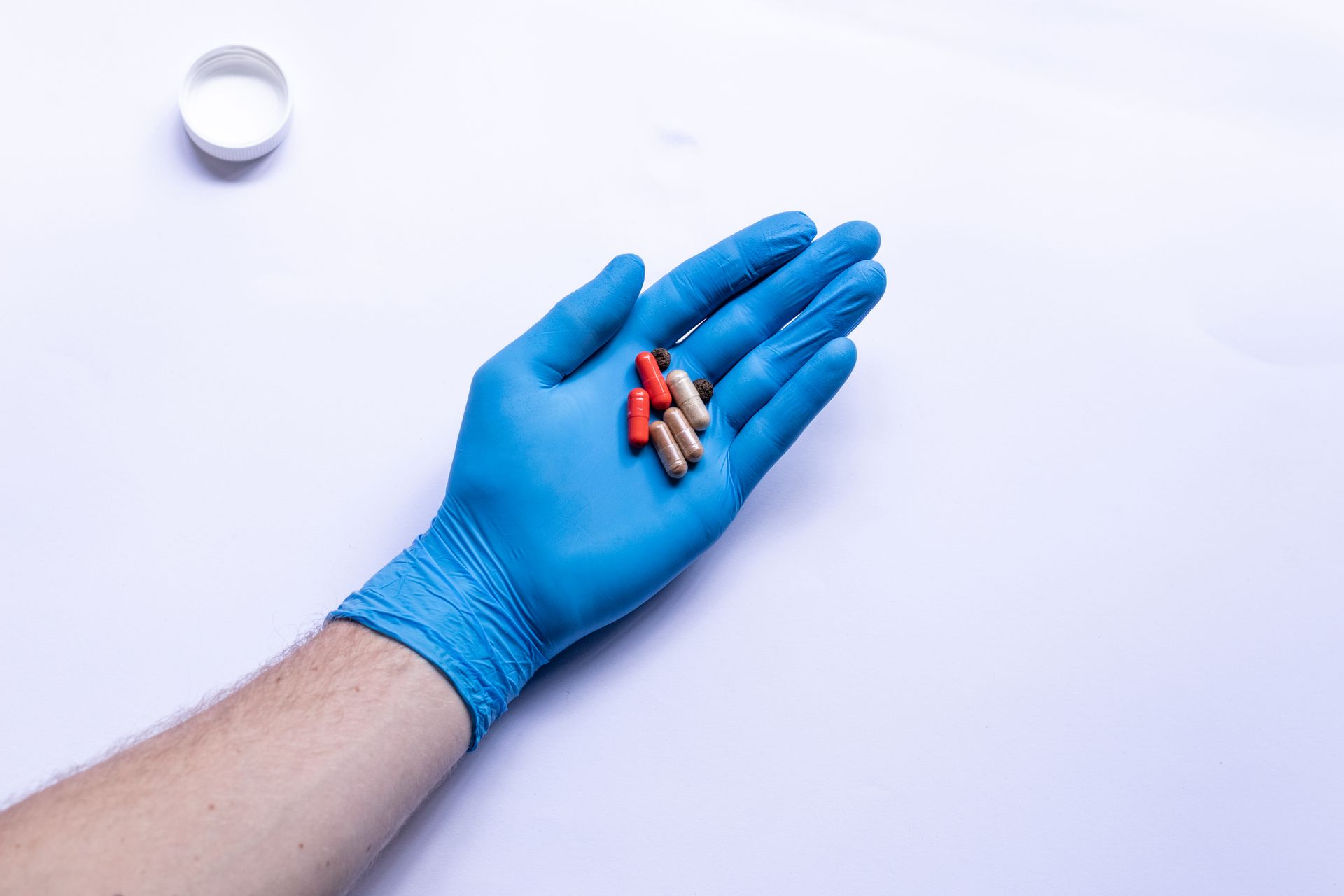 A Person Wearing Medical Glove Holding Medicinal Drugs