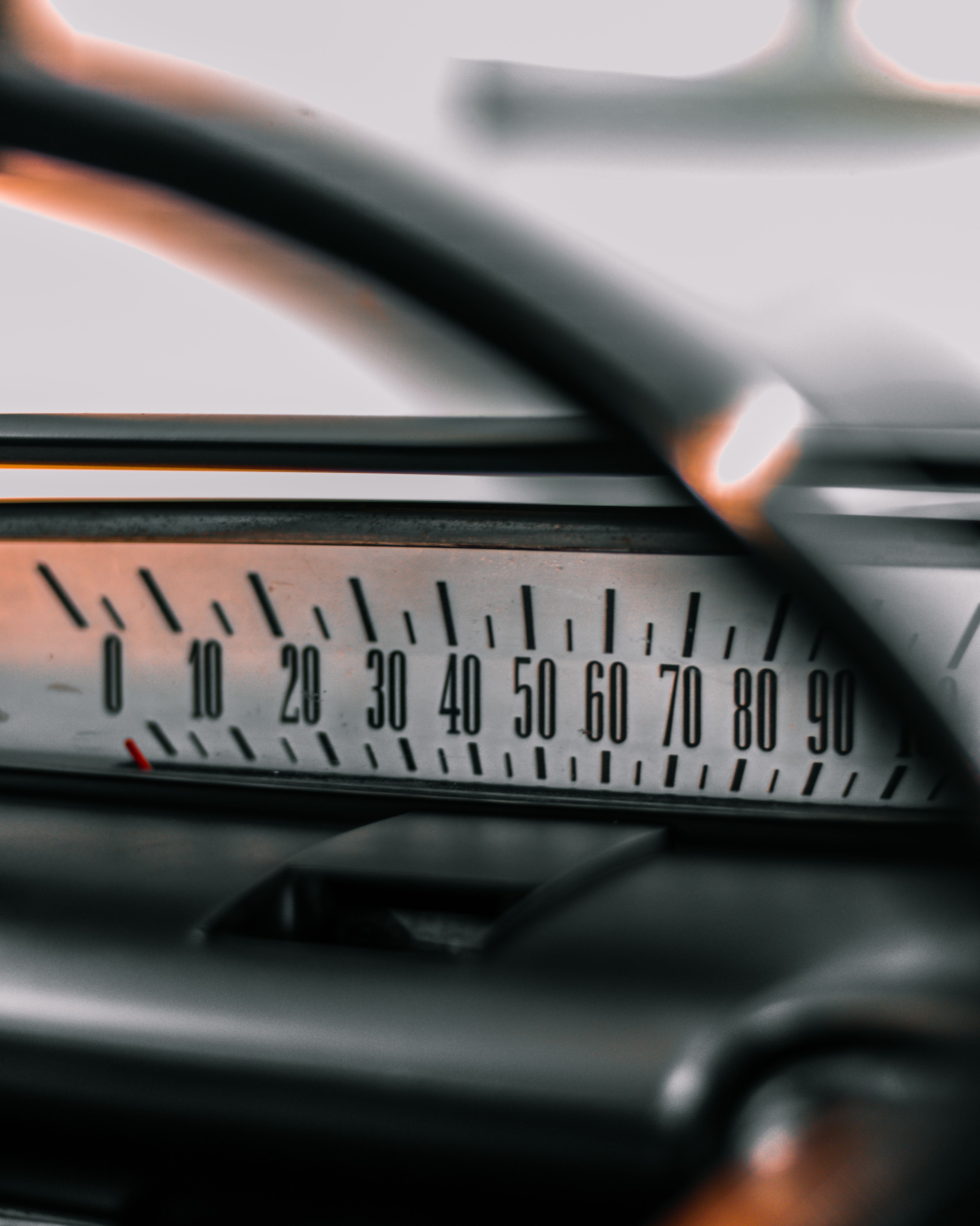 Detailed view of a vintage car speedometer displaying numbers from 0 to 90.