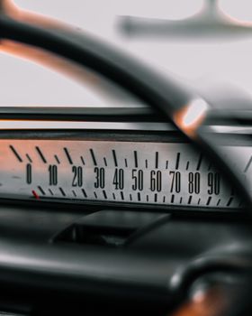 Detailed view of a vintage car speedometer displaying numbers from 0 to 90.