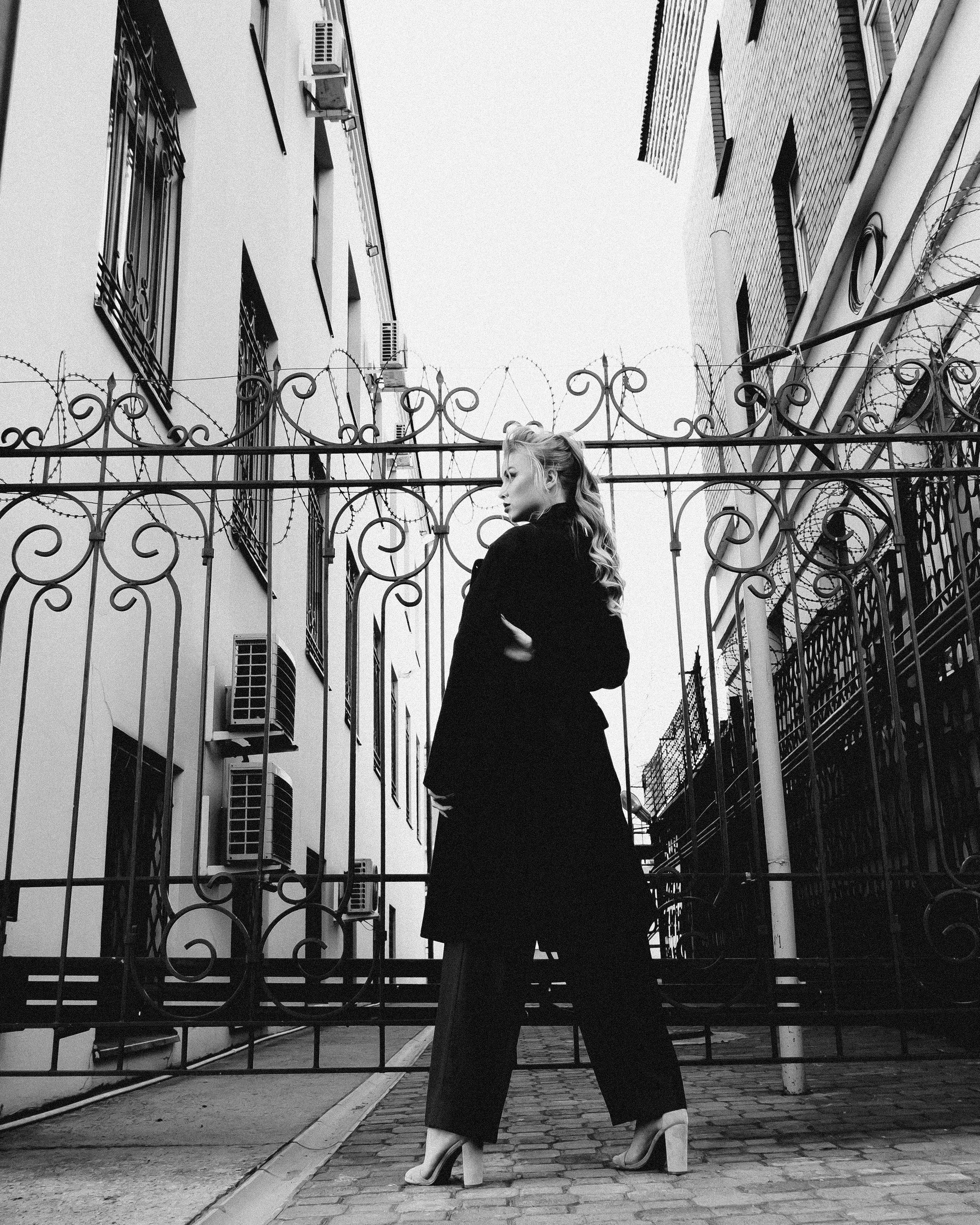 Charming woman near railing against house · Free Stock Photo