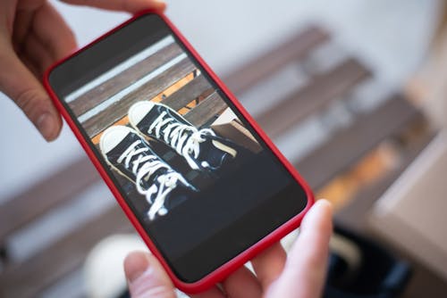 Free Close-Up Shot of a Person Holding and Looking at Screen of a Mobile Phone Stock Photo