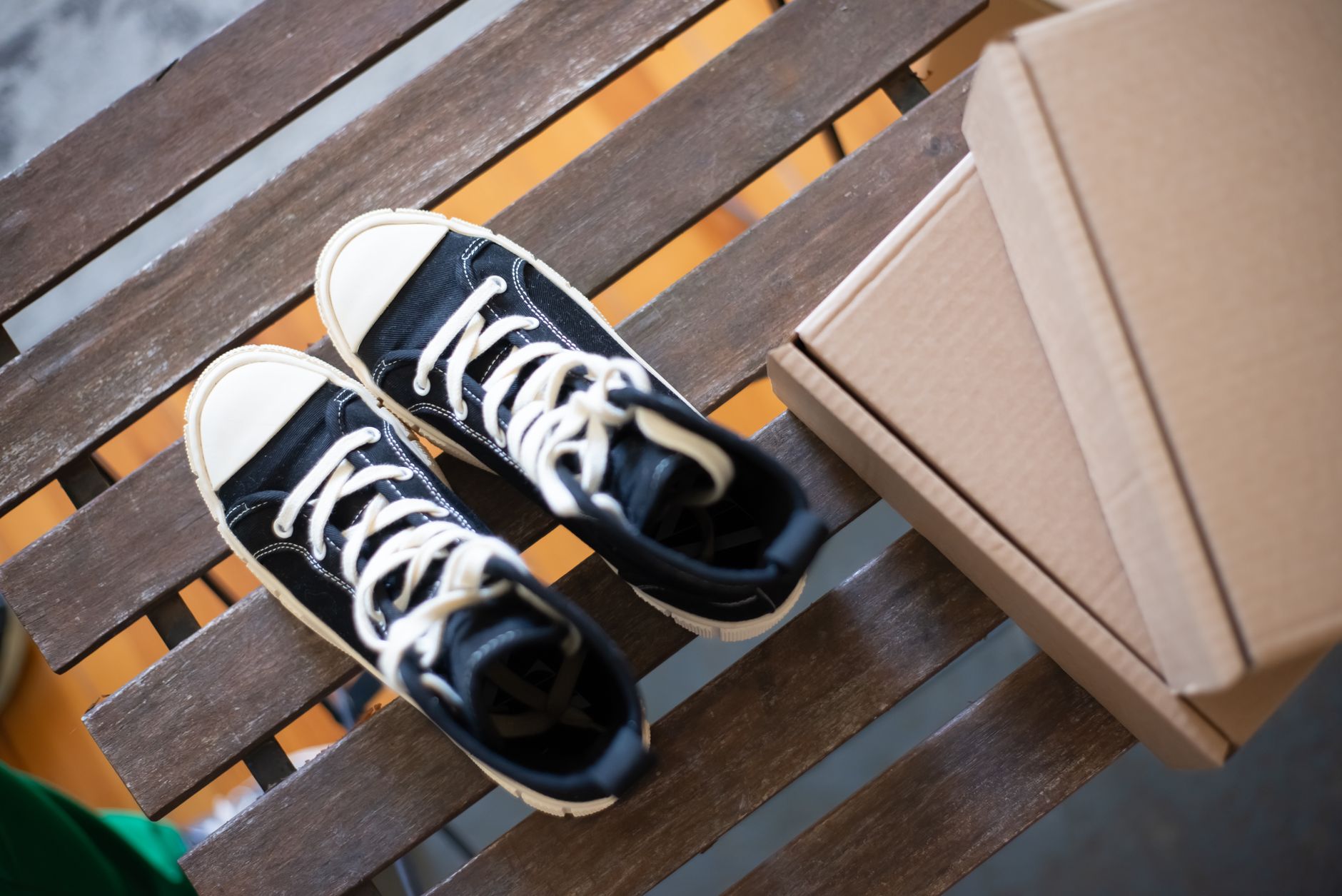 High top sneakers on rustic wooden bench ready for Pika AI video ad generation