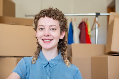 A Woman in Blue Button-Up Shirt Smiling