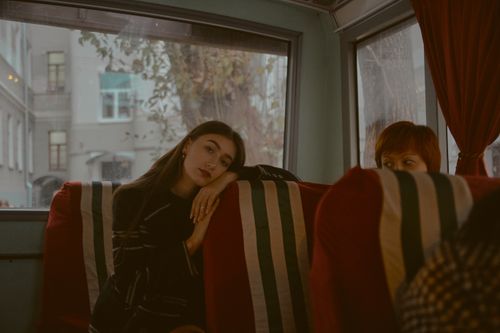 Free Two women sitting on a bus in Moscow, gazing thoughtfully out the window. Stock Photo