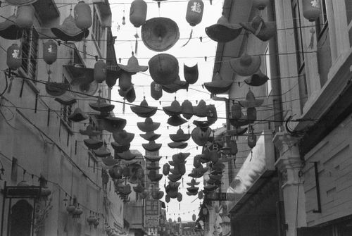 Free Black and white street scene with hanging Chinese lanterns and hats. Stock Photo