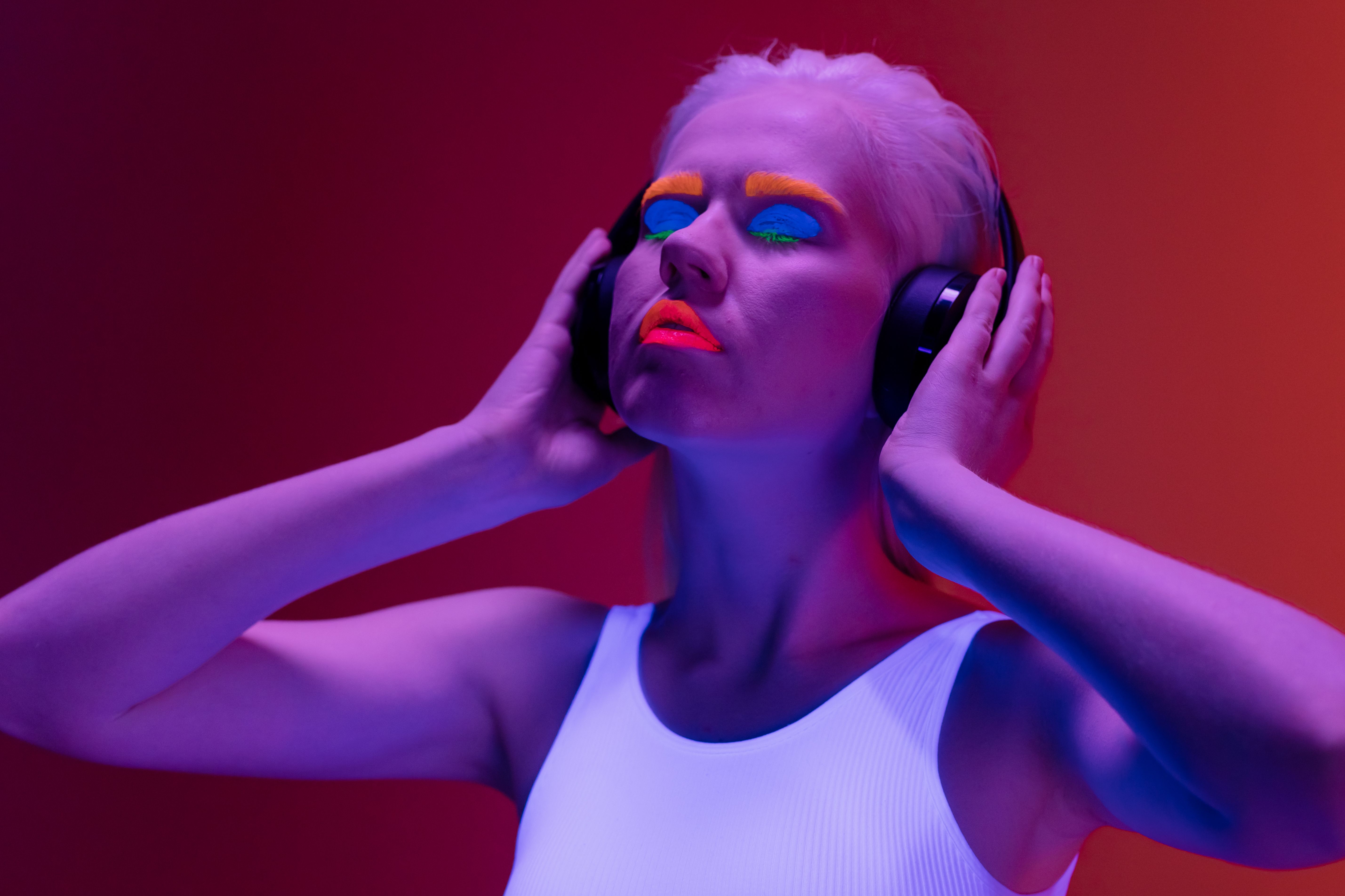 Gen Z listening to music on headphones, neon lights, digital aesthetic