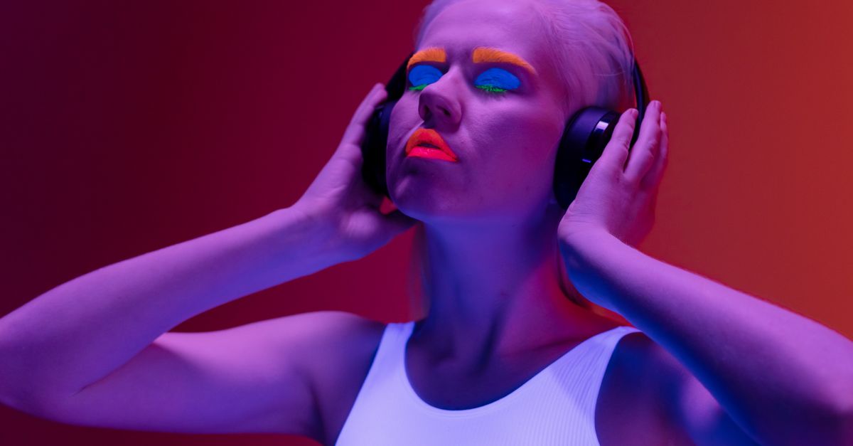Gen Z listening to music on headphones, neon lights, digital aesthetic