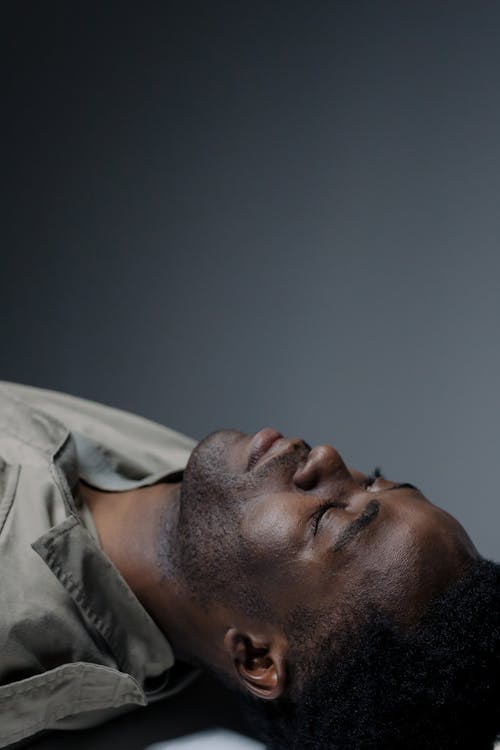 Free A Man Lying Down With His Eyes Closed  Stock Photo