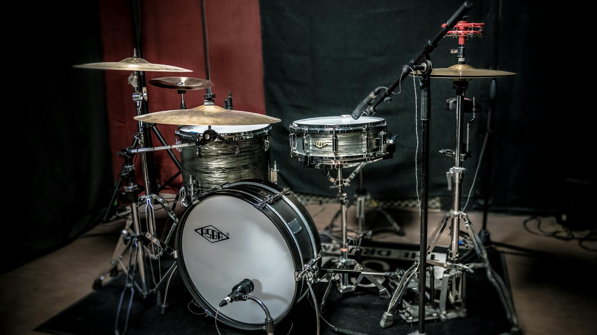 High-quality image of a professional drum kit setup in a recording studio.