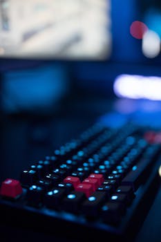 A focused shot of a gaming keyboard with illuminated keys, showcasing modern tech design.