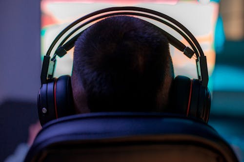 Back View of Person Wearing Black Headphones