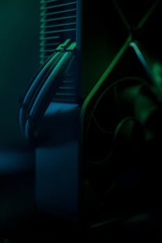 Dark close-up of a gaming PC cooling system with visible wires and fan.