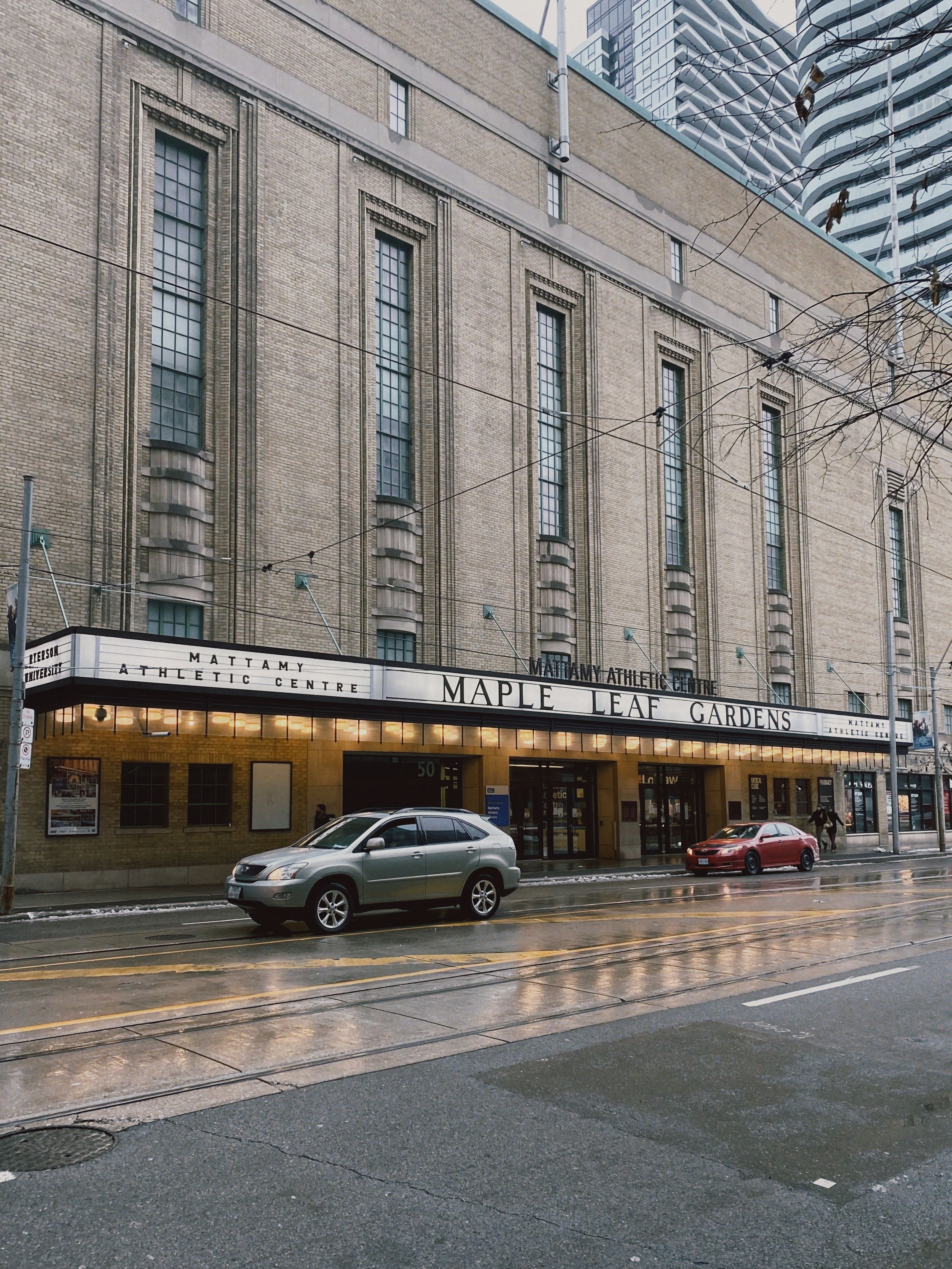 Classic view of Maple Leaf Gardens, a famous Toronto landmark, on a rainy day.
