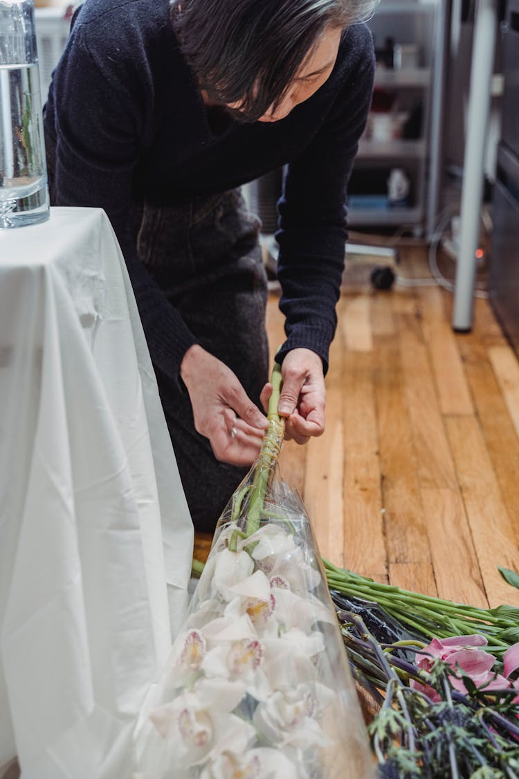 Woman Untying A Knot Of A Bouquet