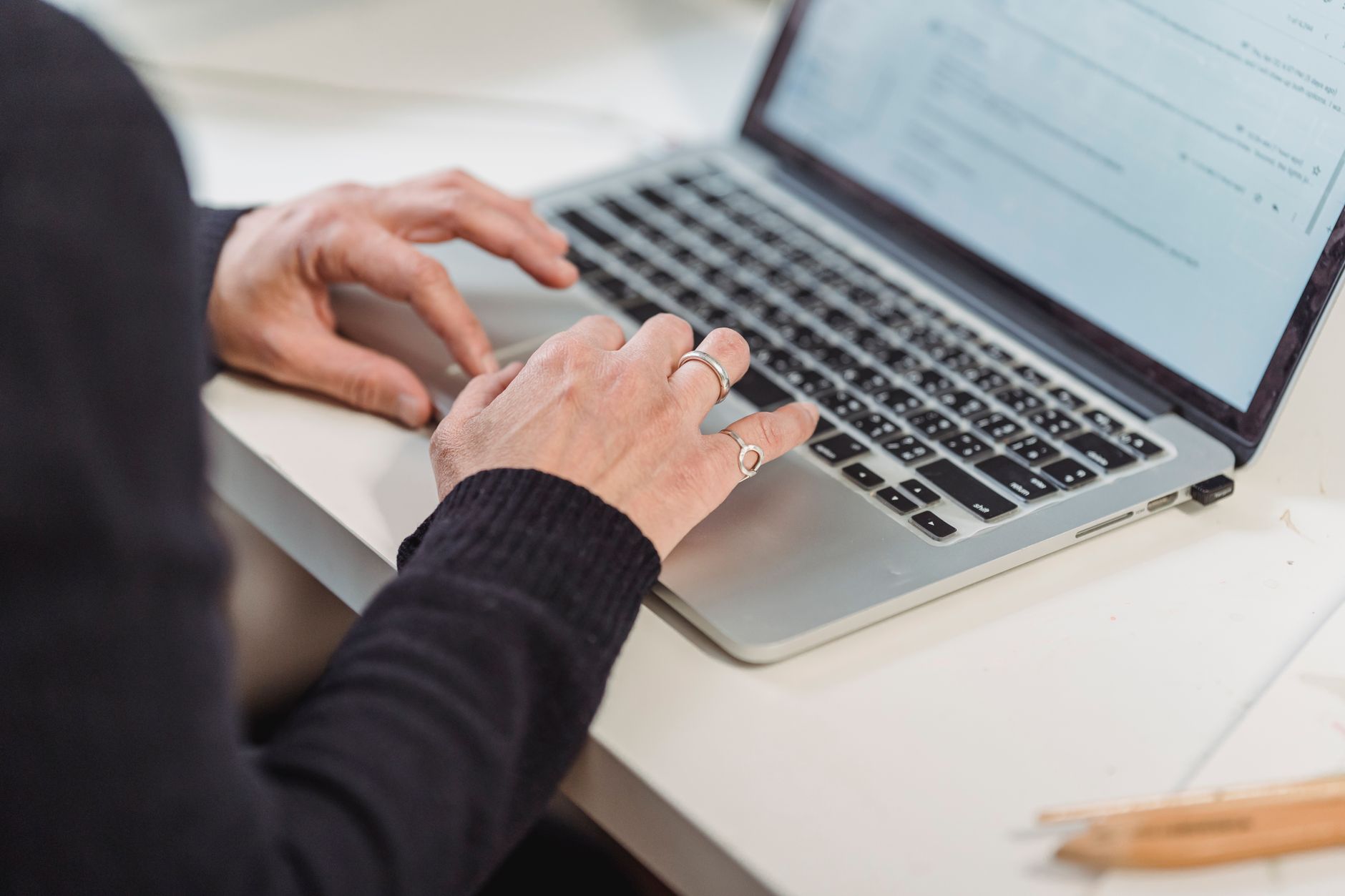 Streamline Success: Top Customer Billing Software for 2026 6 Hands typing on a laptop, focused on financial charts and data